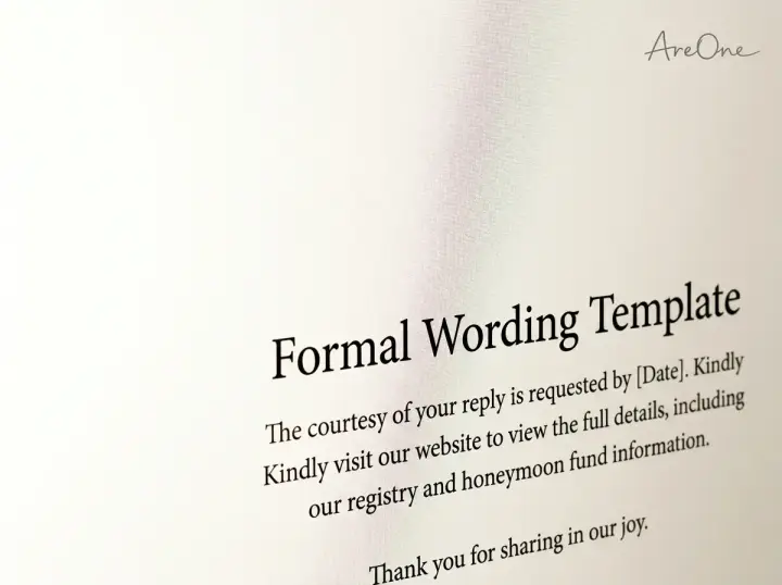 A close-up of beautifully designed formal wedding invitation typography detailing how to politely ask for a honeymoon fund.